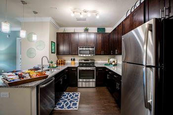 a kitchen with stainless steel appliances and wooden cabinets